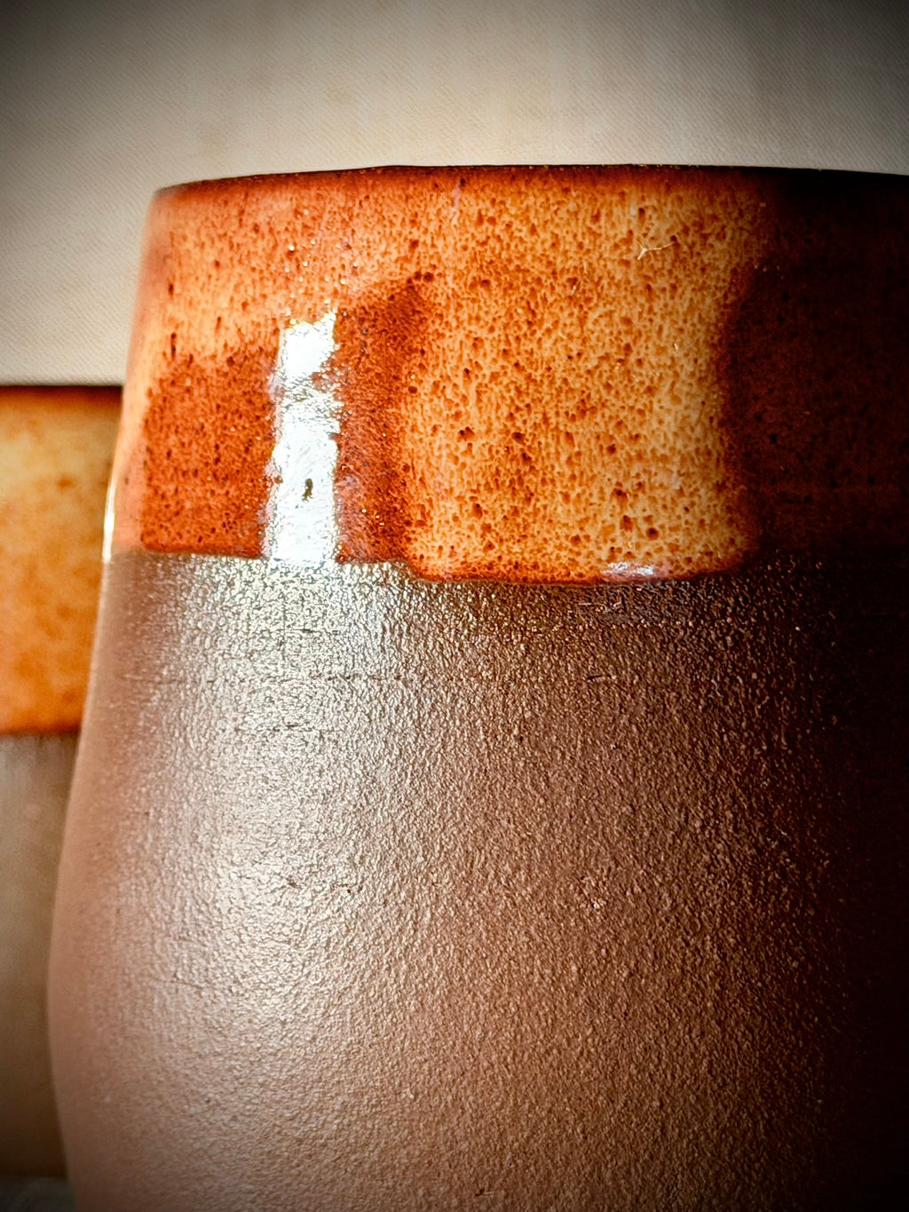 Macro detail of rust glaze surface on a handmade stoneware wine glass