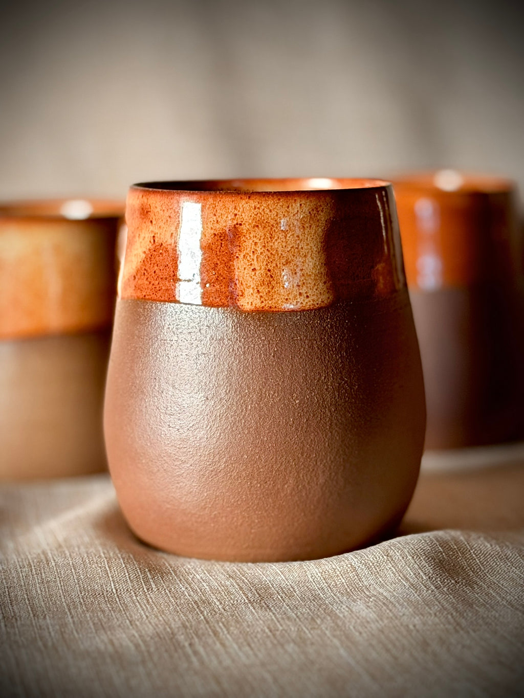Stemless ceramic wine glass in rust and grey stoneware, hand-thrown
