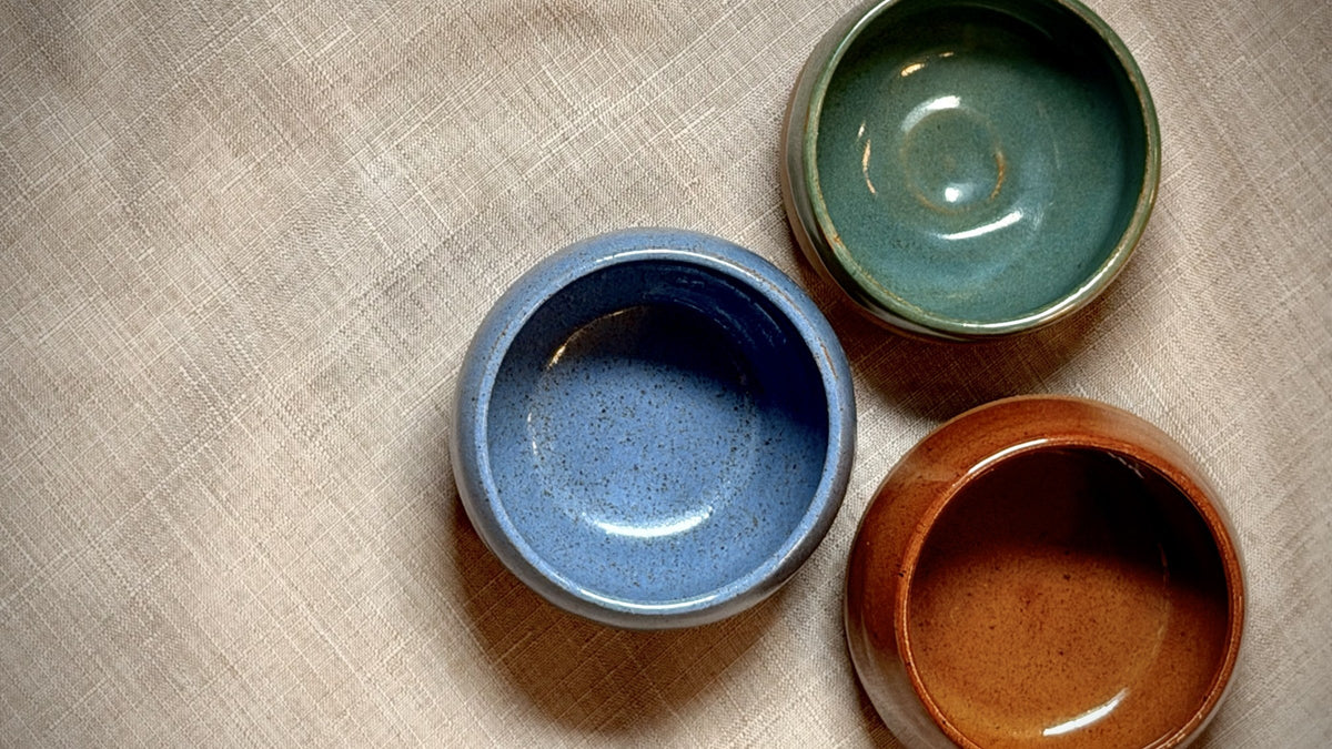 Hand-thrown espresso cups on linen